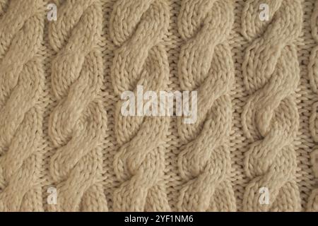 Winter woolen knitting beige sweater clothing. Textile background Stock Photo