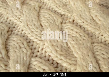 Winter woolen knitting beige sweater clothing. Textile background Stock Photo