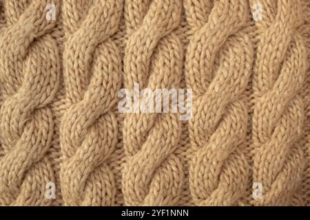 Winter wool hand-knit beige sweater. Clothes textile background Stock Photo