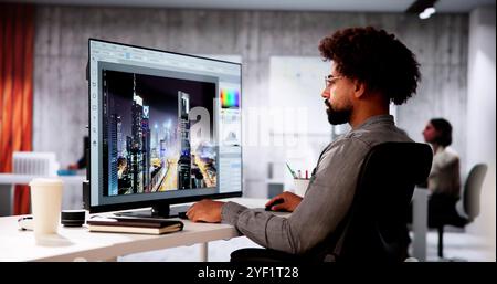 African Graphic Web Designer Using Design Editing Software Stock Photo