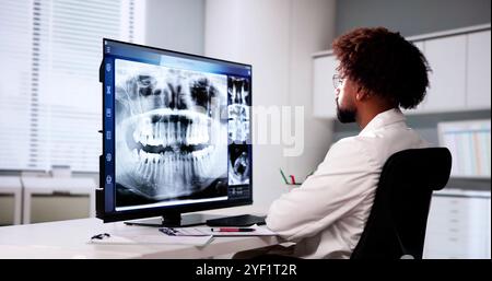 Radiologist Dentist Using X Ray Software On Desktop Computer Stock Photo