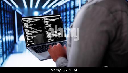 Cloud Computer Engineer Coding In Server Room In Data Center. Configuring AI Technology Stock Photo