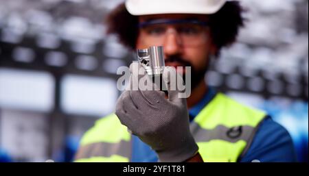 Factory Engineer Checking Metal Part. Modern Industrial Automation Stock Photo