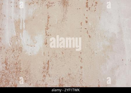 Textured plaster wall surface with peeling paint in various shades of brown and white color. Aged, weathered background. Wallpaper, backdrop, design e Stock Photo