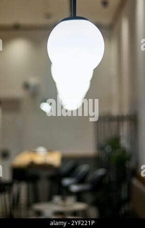 Ceiling lamps illuminated in selective focus and the surroundings out of focus without people Stock Photo