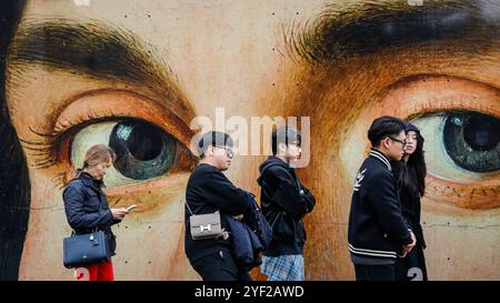 London, UK. 02nd Nov, 2024. Long queues have formed for entry to the National Gallery, with visitors patiently waiting all along the temporary construction fence that features colourful images. The museum currently shows a Van Gogh exhibition, as well as other collections. Credit: Imageplotter/Alamy Live News Stock Photo