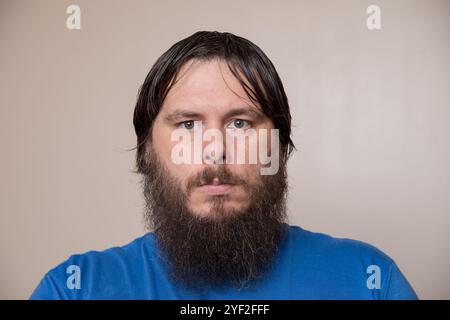 Portrait of a Bearded Man in a Blue Shirt Stock Photo