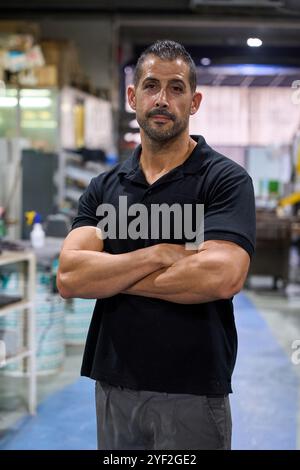 Metalworker operating cnc machine in modern factory Stock Photo