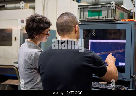 Smiling workers walking and talking in a factory Stock Photo