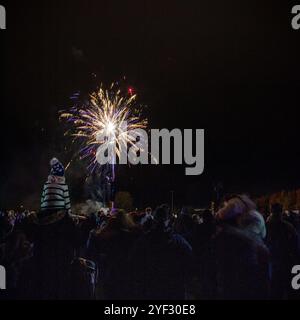 Crowds watching the Bicester Round Table 2024 annual fireworks display in Pingle Field, Bicester, Oxfordshire. Stock Photo