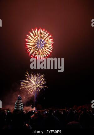 Crowds watching the Bicester Round Table 2024 annual fireworks display in Pingle Field, Bicester, Oxfordshire. Stock Photo