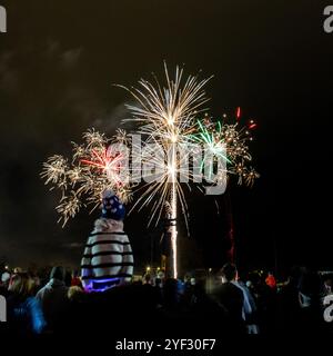 Crowds watching the Bicester Round Table 2024 annual fireworks display in Pingle Field, Bicester, Oxfordshire. Stock Photo