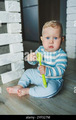 Happy smiling child. A cute little newborn baby boy with a smiling face is crawling on the floor. Motherhood baby care concept happy baby Stock Photo