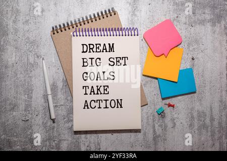 Motivational and inspirational quote on notepad with pen - Dream big set goal take action Stock Photo