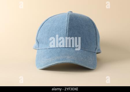 Stylish denim baseball cap on beige background, closeup. Mockup for design Stock Photo