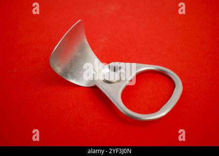 Silver Pull Tab on a Red Background Stock Photo