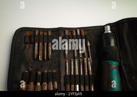 Tool set with multiple screwdrivers and bits in a fabric pouch Stock Photo