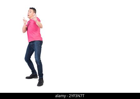 Cheerful young man pointing at camera in white studio Stock Photo