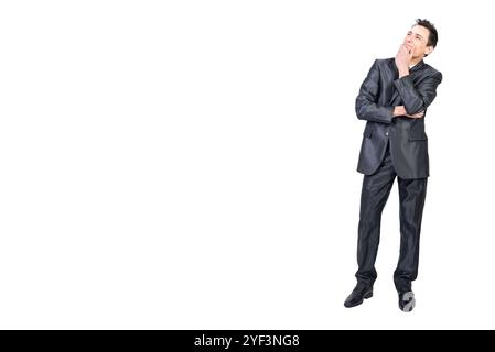 Dreamy businessman touching chin and thinking in studio Stock Photo