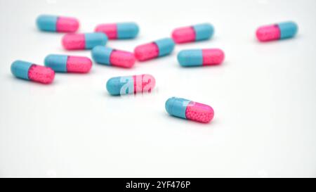 Transparent capsule with sustained release granule. Pellets in transparent hard gelatin capsule on white background. Stock Photo