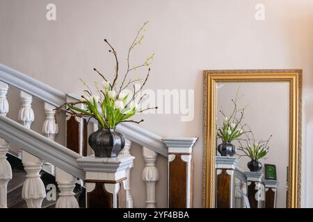 Simple spring flower arrangement of white tulips and blossoming branches. Stock Photo