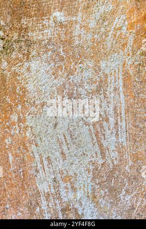 textured beige plaster wall background. The surface shows rough, uneven areas and streaks of white residue Stock Photo