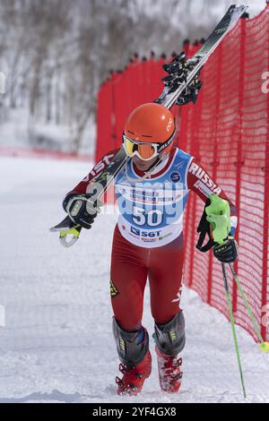 MOROZNAYA MOUNT, KAMCHATKA PENINSULA, RUSSIA, MARCH 28, 2019: Russian Alpine Skiing Cup, slalom. Mountain skier Shishkin Vitaliy Altai Region climbs o Stock Photo