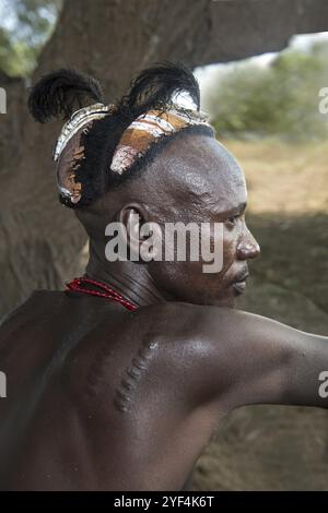 Young man with traditional clay headdress and scarred tattoos, Dassanetsch ethnic group, Southern Omo Valley, Ethiopia, Africa Stock Photo