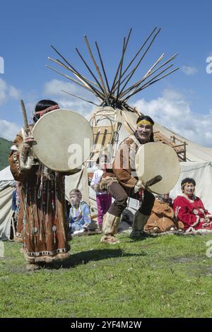 PETROPAVLOVSK CITY, KAMCHATKA PENINSULA, RUSSIA, JULY 11, 2015: Man and woman in national clothing aborigine of Kamchatka expression dancing with tamb Stock Photo