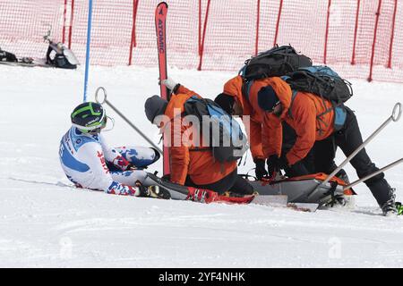 KAMCHATKA, RUSSIA, MARCH 28, 2019: Rescuers Kamchatka Rescue Squad provide first aid to sportsman who is injured before evacuated on rescue stretcher Stock Photo