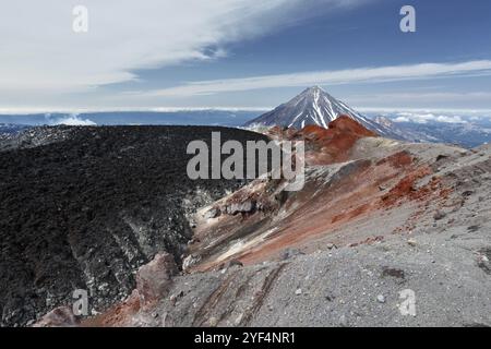 Summer volcanic landscape: beautiful view of active crater Avacha Volcano on Kamchatka Peninsula on background Koryaksky Volcano in sunny weather. Far Stock Photo