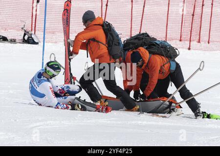 KAMCHATKA, RUSSIA, MARCH 28, 2019: Rescuers Kamchatka Rescue Squad provide first aid to sportsman who is injured before evacuated on rescue stretcher Stock Photo