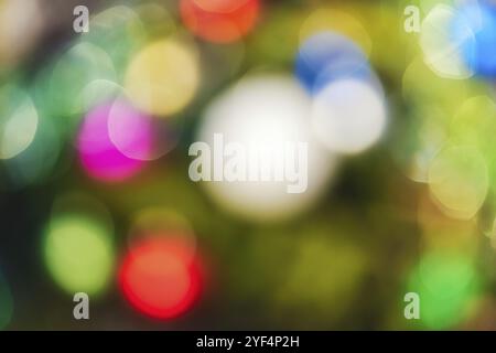 Defocused colorful Christmas holiday decorations, abstract blurry bokeh background effect. Out of focus glowing lights celebration texture for use at Stock Photo