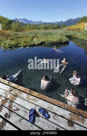 NALYCHEVO NATURE PARK, KAMCHATKA PENINSULA, RUSSIA, SEP 7, 2013: Hot springs in Nalychevo Nature Park, group of people take a therapeutic (medicinal) Stock Photo