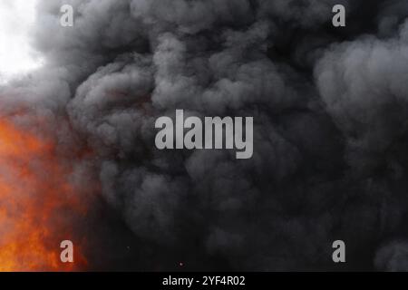 Black motion clouds of strong fire smoke covered sky. Defocus and ...