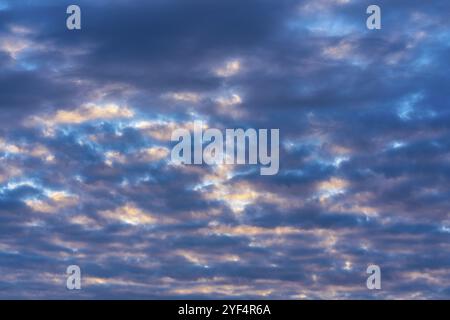 Beautiful clouds in blue sky, illuminated by rays of sun at colorful sunset to change weather. Soft focus, motion blur abstract summer meteorology lan Stock Photo