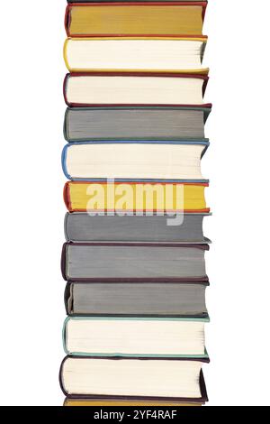 Stack of hardcover books on bookshelf. Close up view of multi colored vintage hardback books isolated on white background Stock Photo