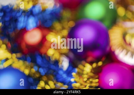 Defocused colorful Christmas balls holiday decorations, abstract blurry bokeh background effect. Out of focus glowing lights celebration texture for u Stock Photo