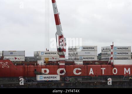 Crane unloaded Russian container cargo ship Sevmorput, nuclear-powered icebreaker lighter aboard ship carrier. Terminal commercial sea port. Kamchatka Stock Photo