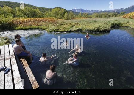 NALYCHEVO NATURE PARK, KAMCHATKA PENINSULA, RUSSIA, SEP 7, 2013: Group hot springs in Nalychevo Nature Park, people take a therapeutic (medicinal) bat Stock Photo