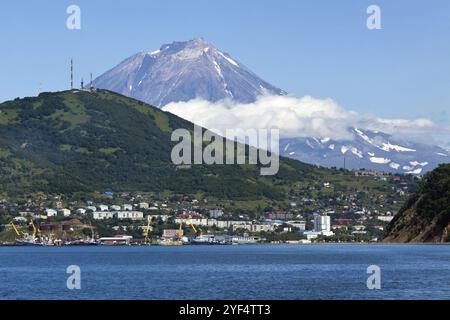 Summer seascape of Kamchatka Peninsula: view of Petropavlovsk-Kamchatsky City, Avacha Bay (Pacific Ocean) and active Koryak Volcano (Koryaksky Volcano Stock Photo