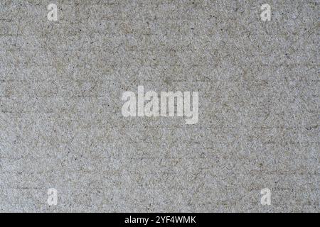 Close-up detail view of light brown background from sheet of recycled cardboard. Abstract texture recycled eco-friendly material pattern background Stock Photo