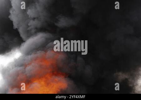Black motion clouds of strong fire smoke covered sky. Defocus and ...