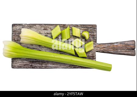 Sliced uncooked celery sticks on wooden cutting board isolated on white background, top view. Stock Photo