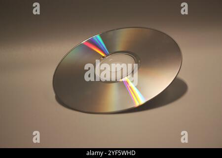 A Compact Disc or CD angled to the light Stock Photo