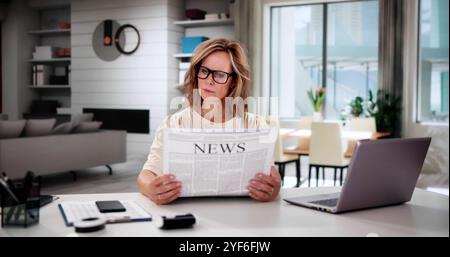 Woman Reading Newspaper At Home. News And Events Stock Photo