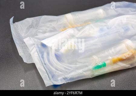 Device for infusion of blood substitutes and infusion solutions package closeup on black. Stock Photo