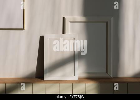 Close-up of blank picture frames in the sunlight on a shelf in a living room Stock Photo