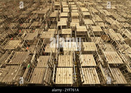Many empty roll containers next to each other in a large hall. Stock Photo