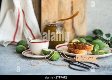 Close-up of a cup of black coffee and sliced white sourdough bread with feijoa jam on a table Stock Photo